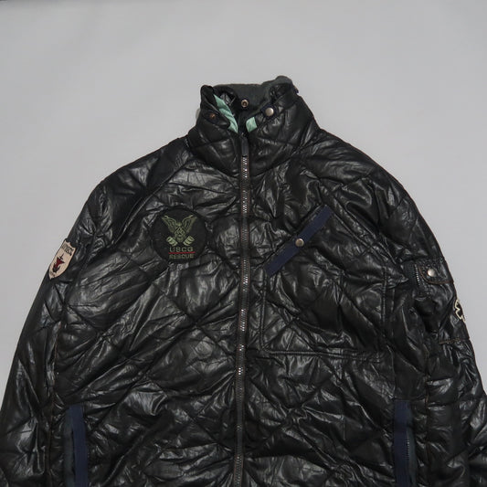 Black quilted jacket with USCG Rescue and various patches.