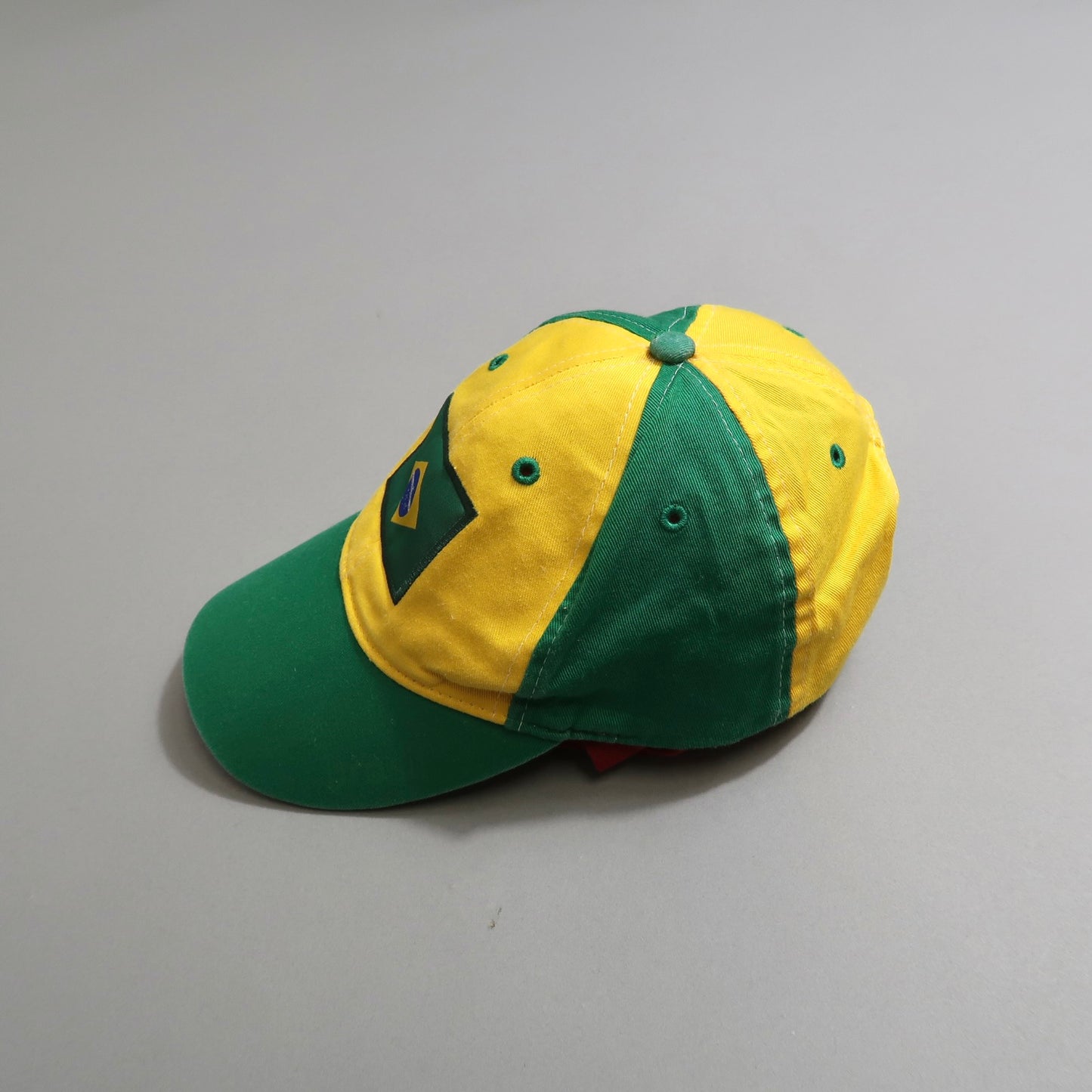 Yellow and green cap with a flag patch on the side.