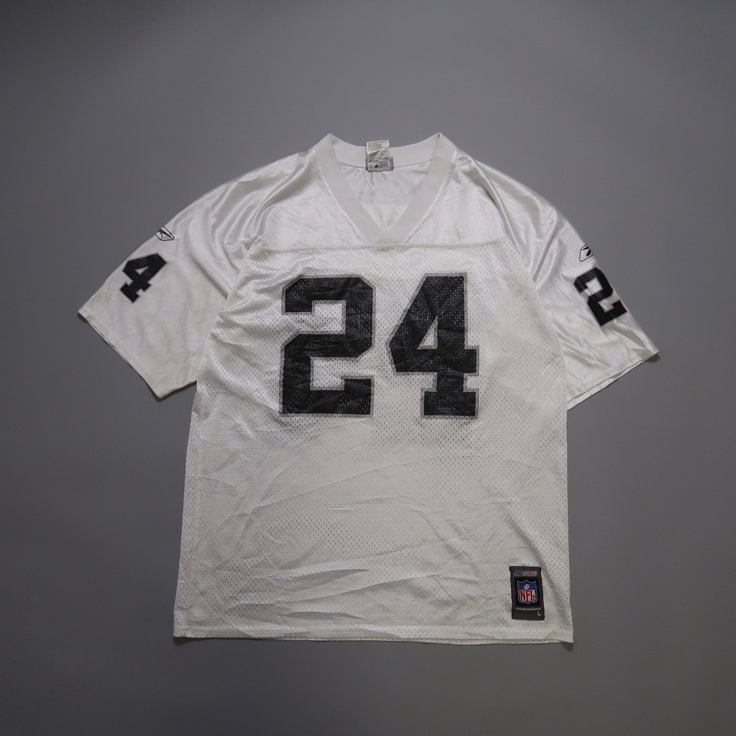 White sports jersey with black number 24 on front and sleeves.