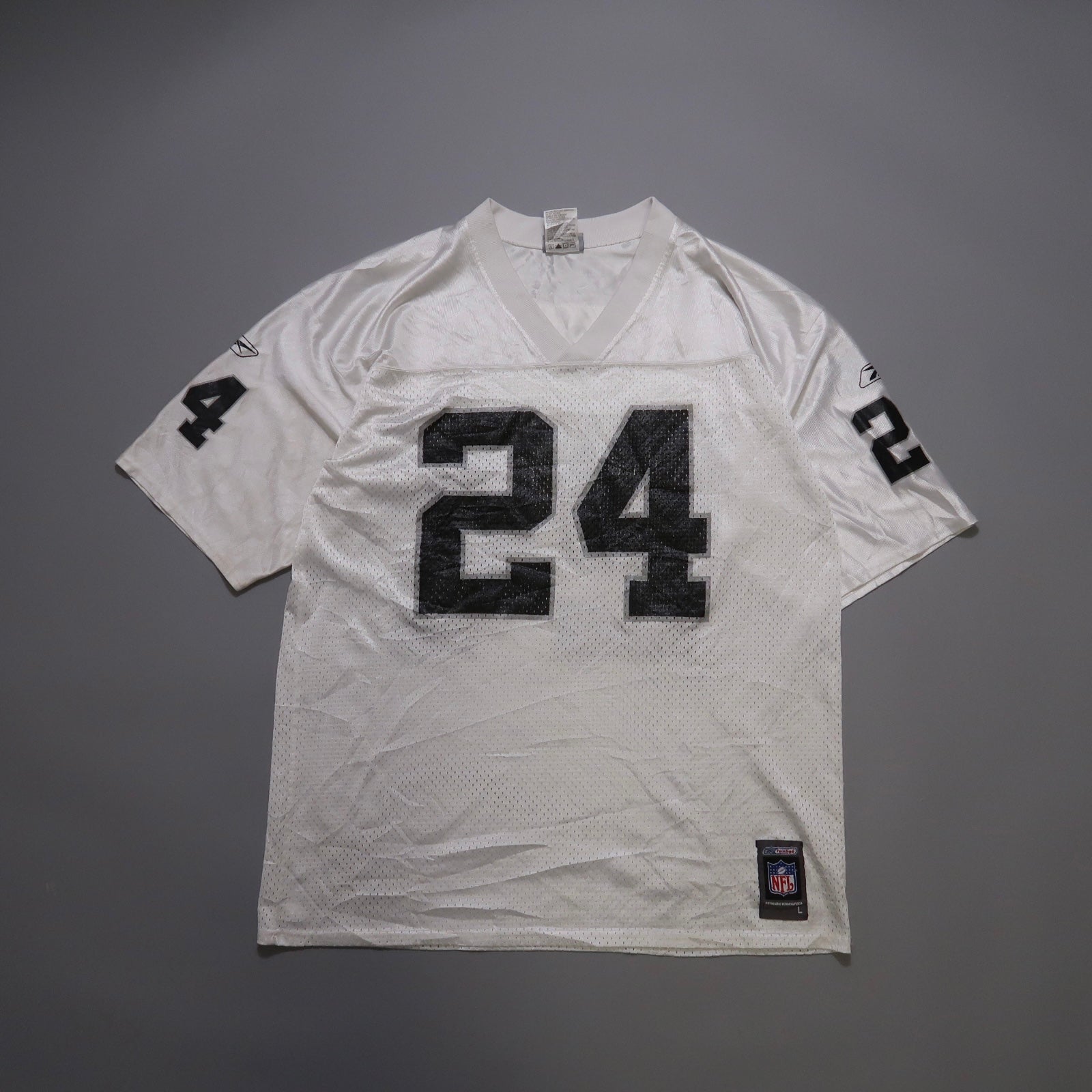 White sports jersey with black number 24 on front and sleeves.