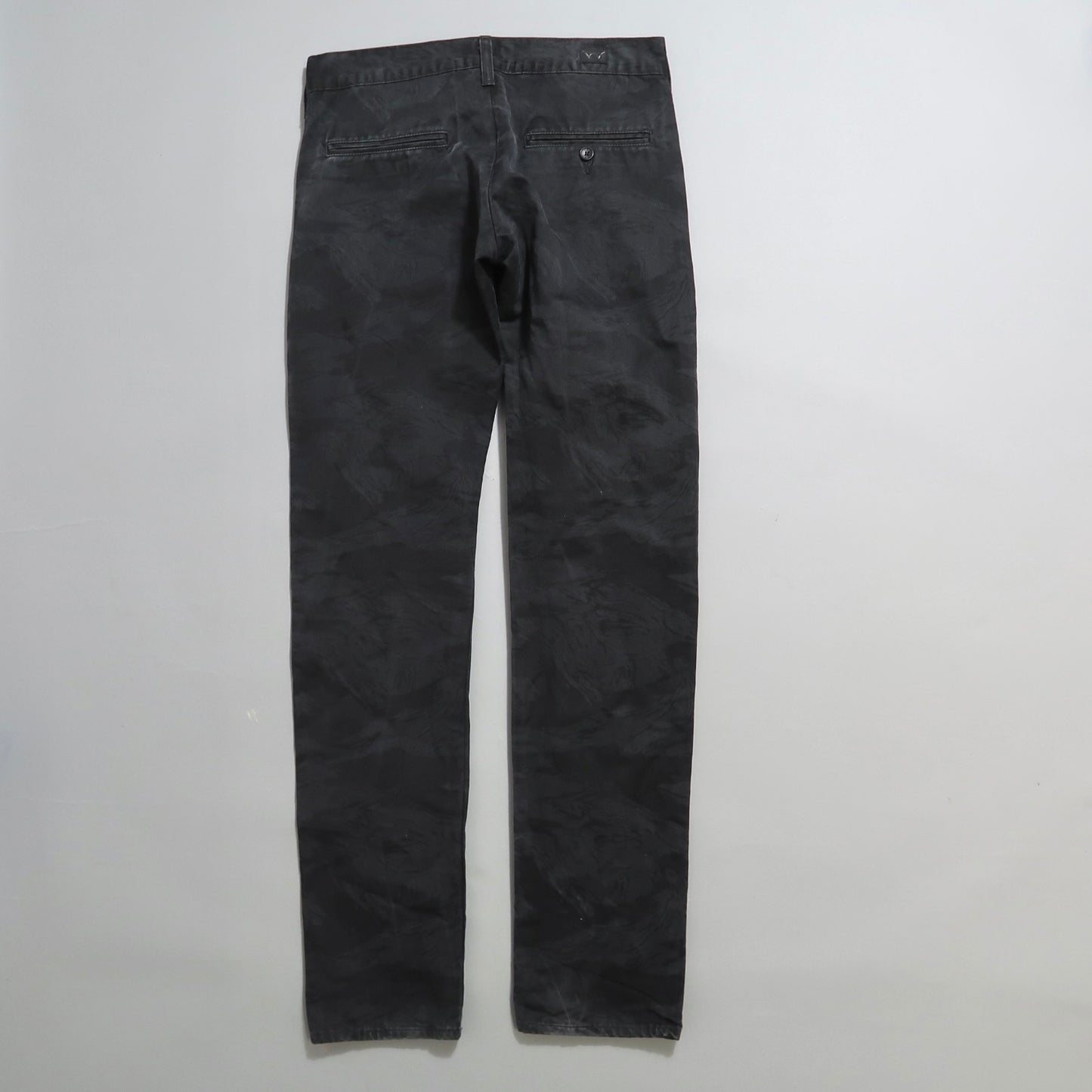 Back view of black camo-patterned pants on a white background.