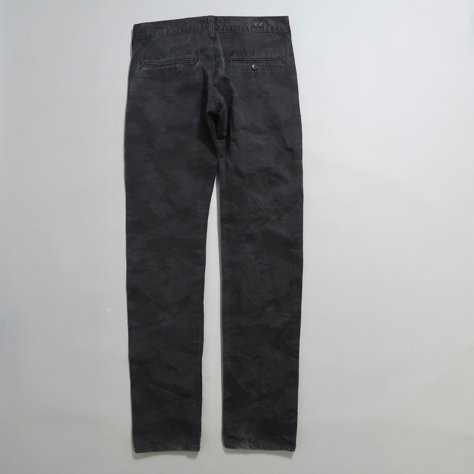 Back view of black camo-patterned pants on a white background.