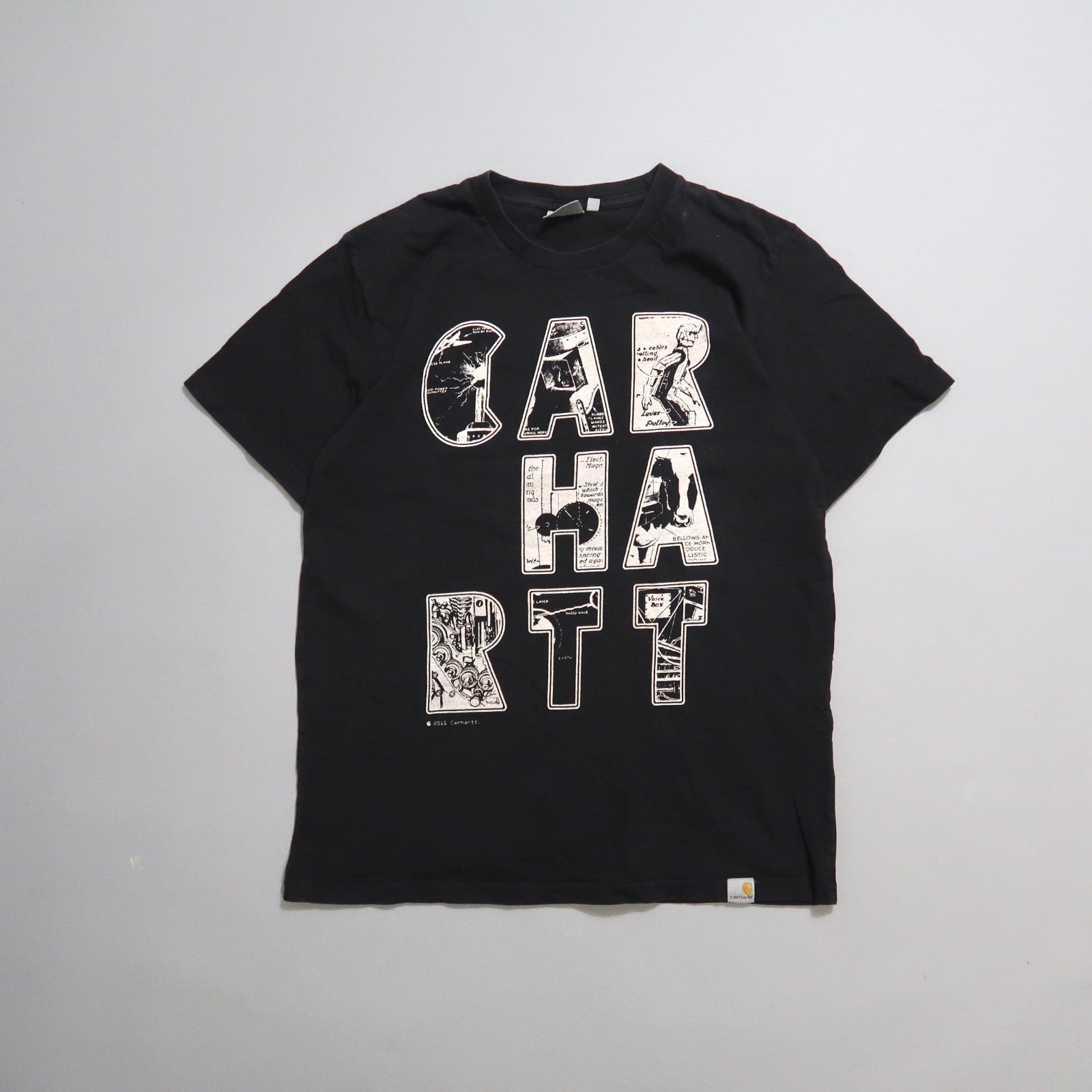 Black T-shirt with nullCARHARTTnull in illustrated letters.