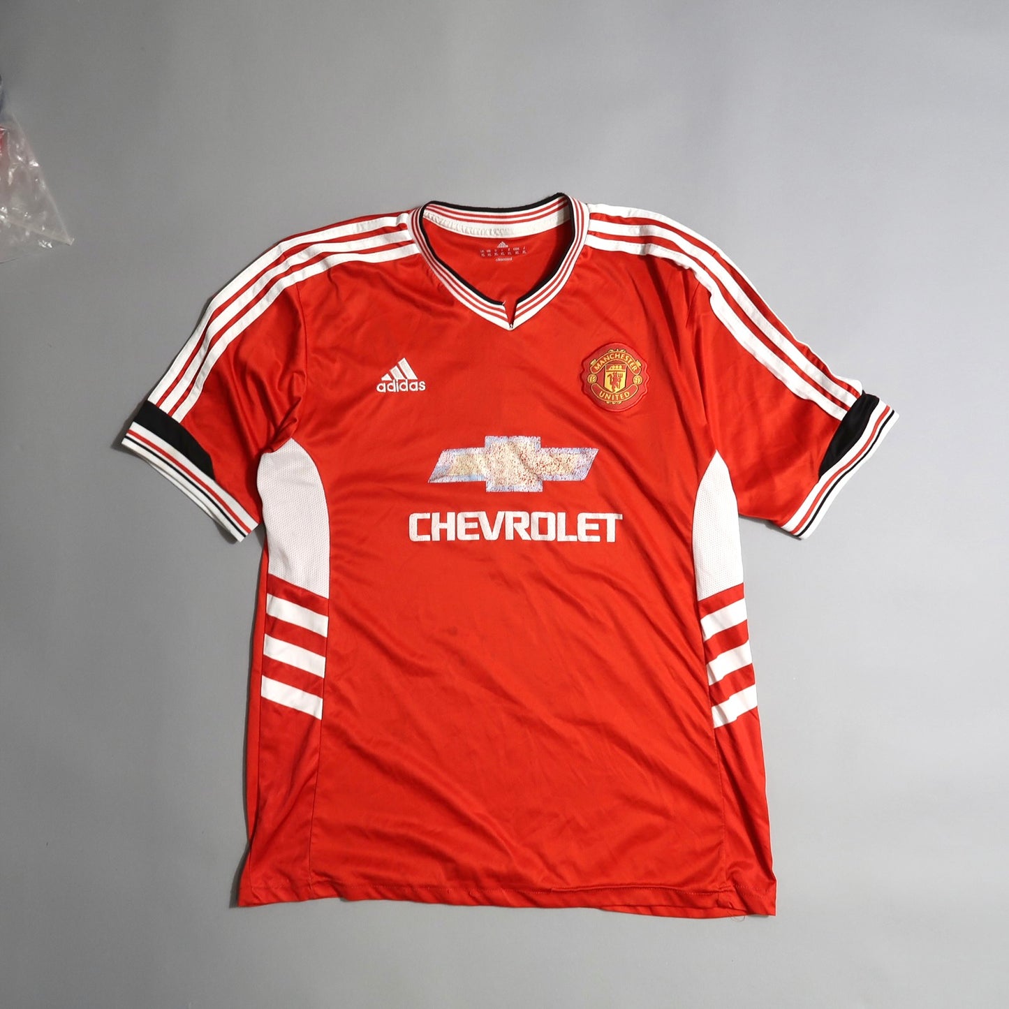 Red Manchester United jersey with Adidas and Chevrolet logos.