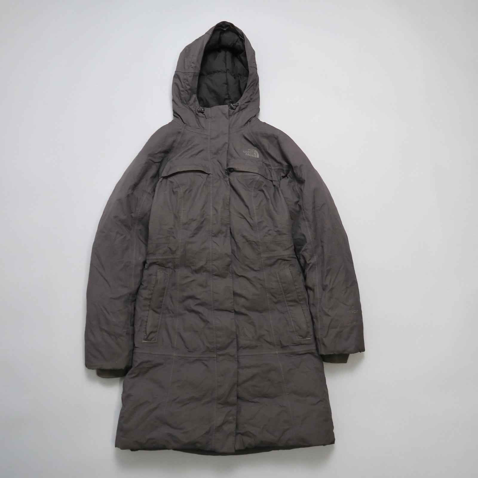 Gray hooded winter coat against a neutral background.