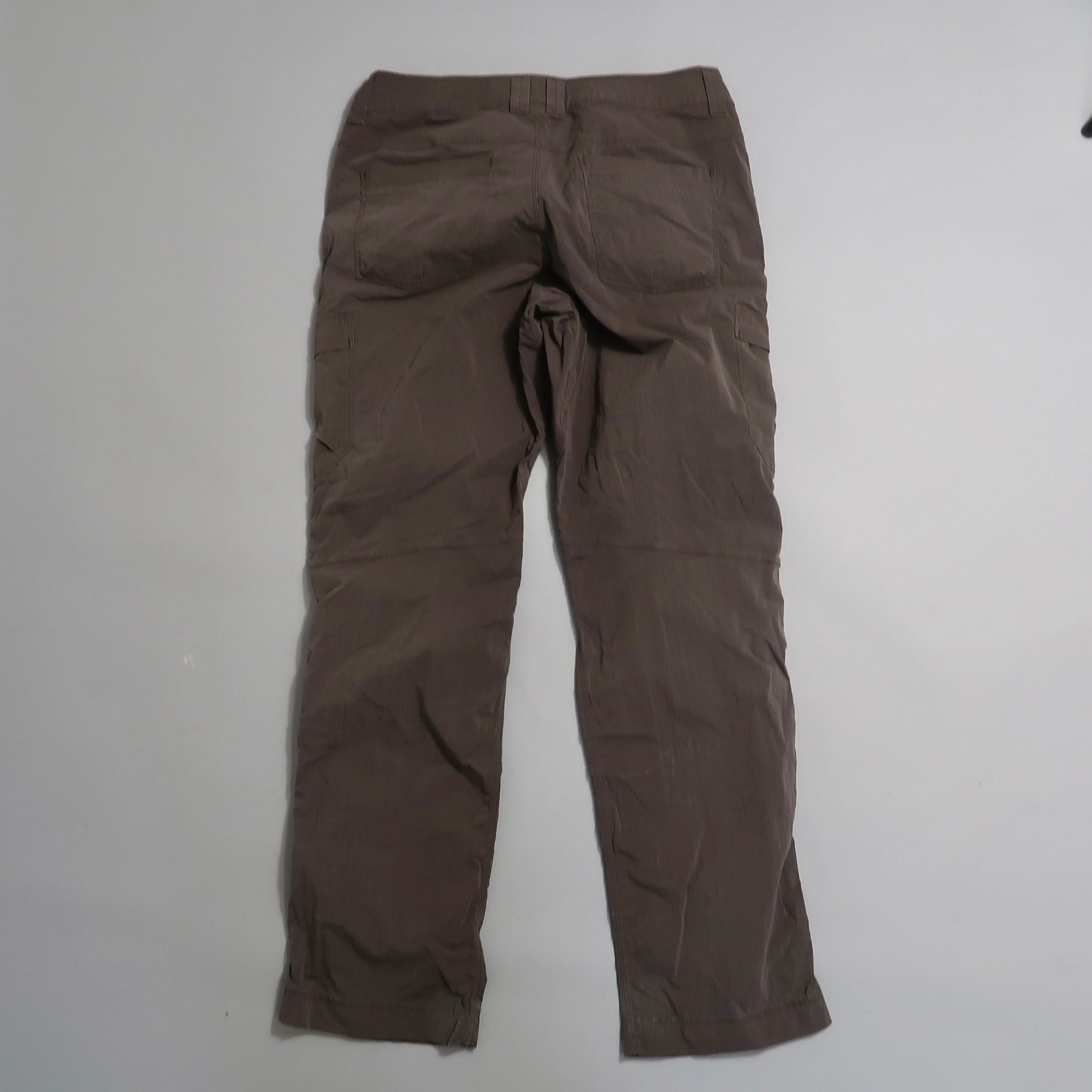 Brown pants displayed on a neutral background.