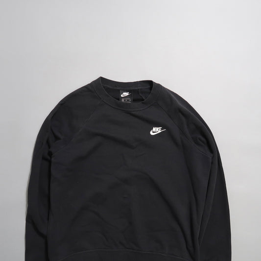 Black Nike sweatshirt with logo on a light gray background.