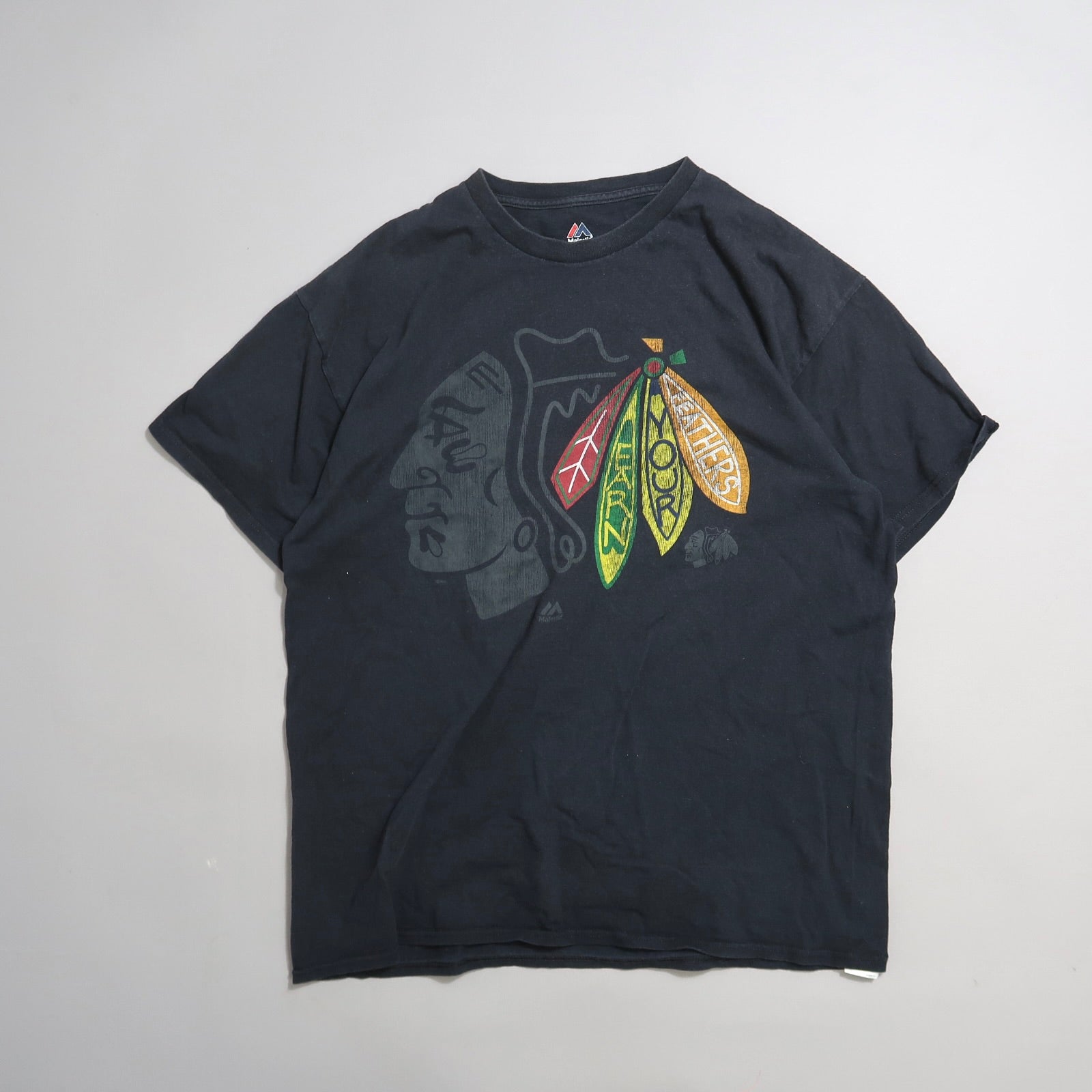 Black t-shirt with colorful feather design and profile silhouette.