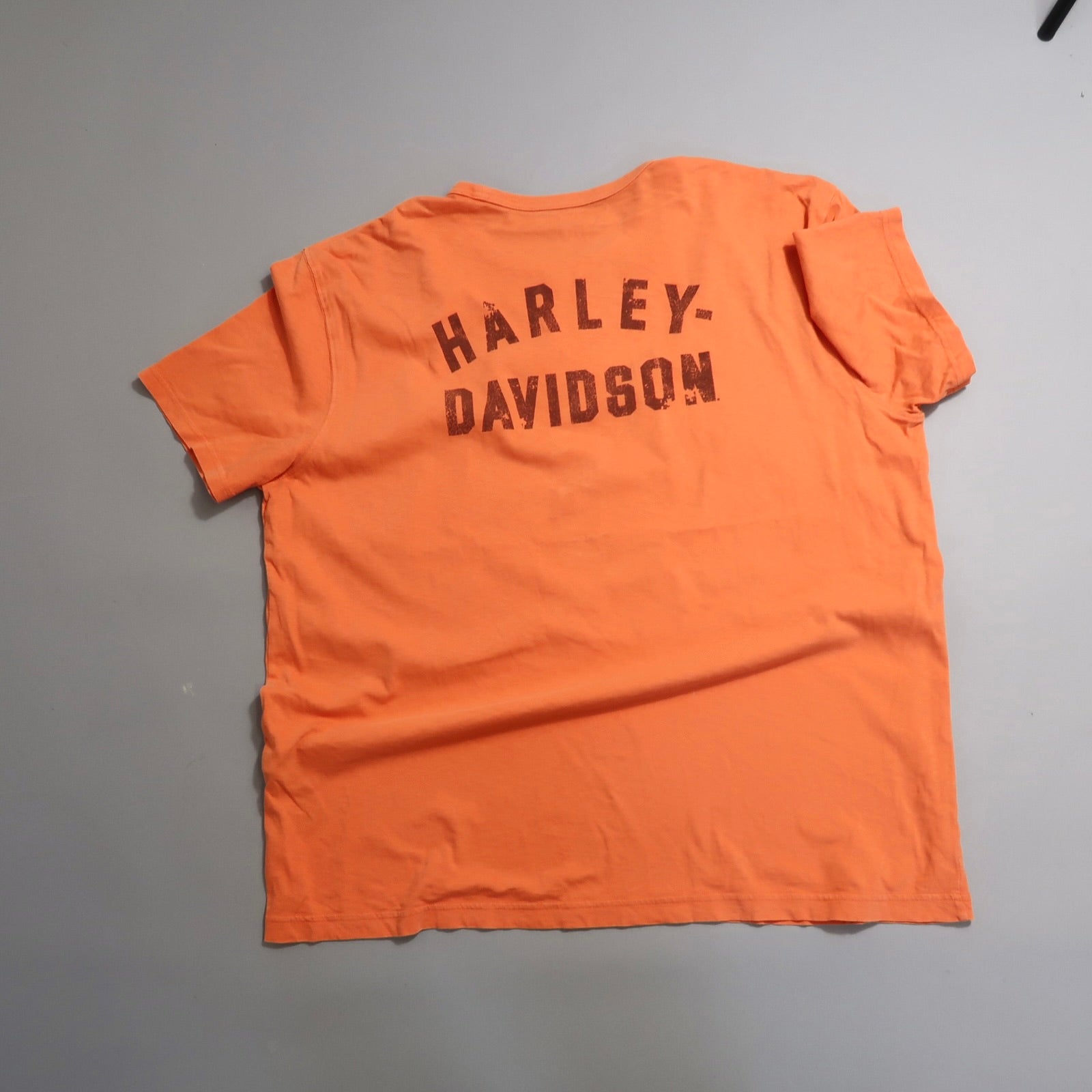 Orange T-shirt with nullHARLEY-DAVIDSONnull printed on the back.