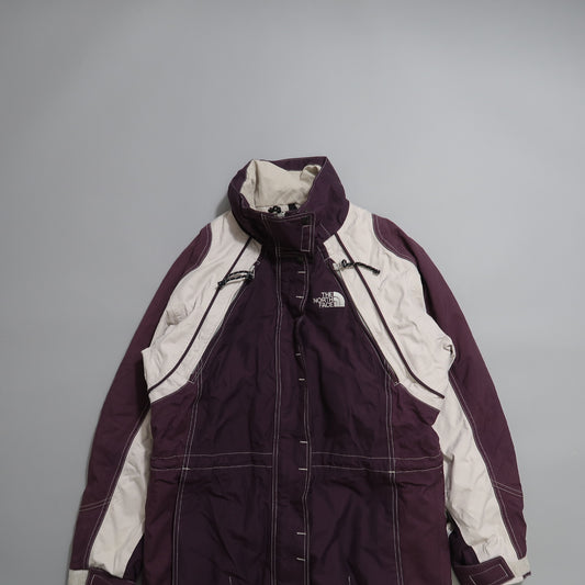 Purple and gray North Face jacket on gray background.
