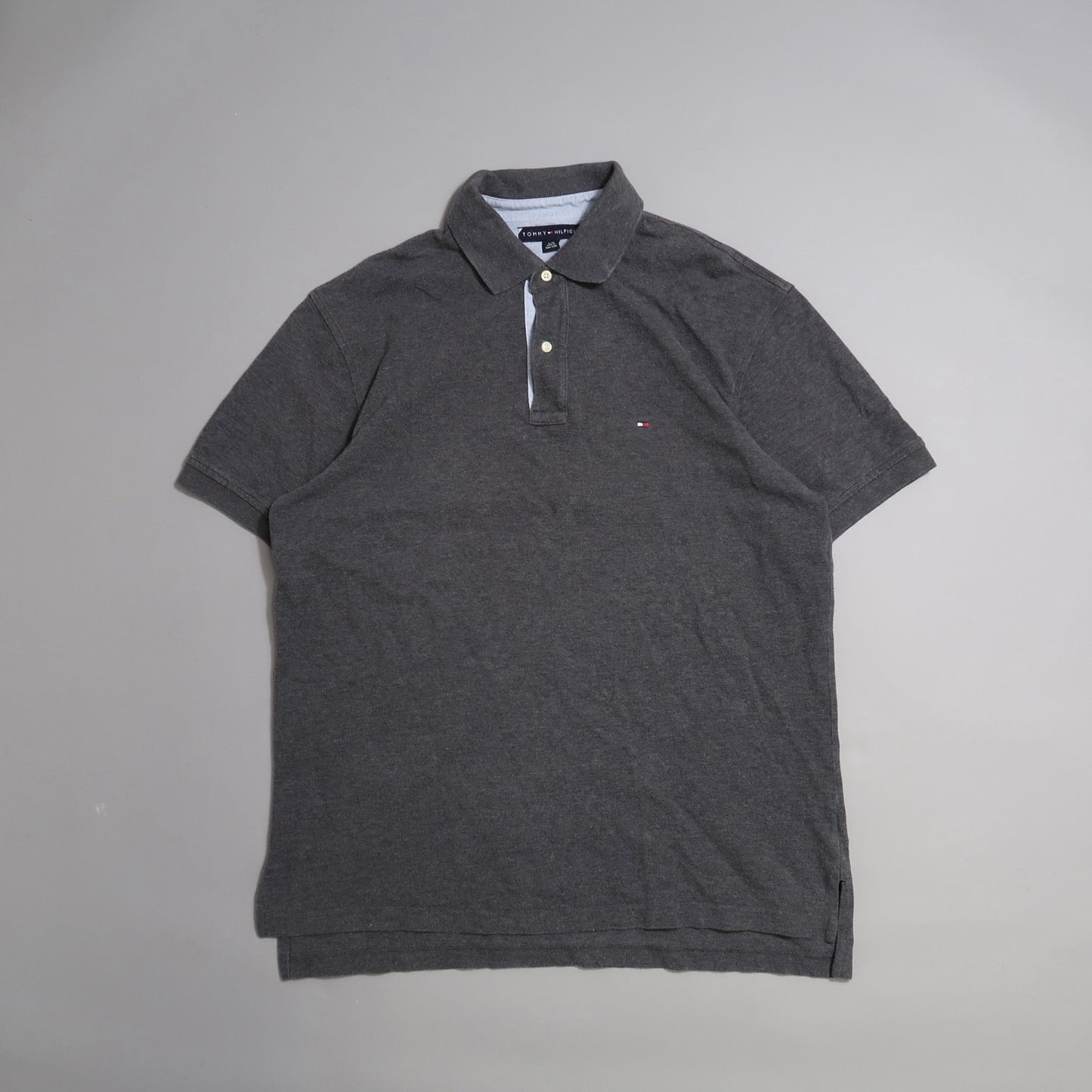 Dark gray polo shirt on a plain background.