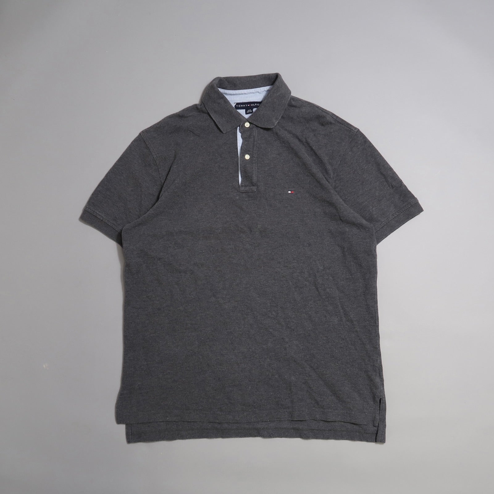 Dark gray polo shirt on a plain background.