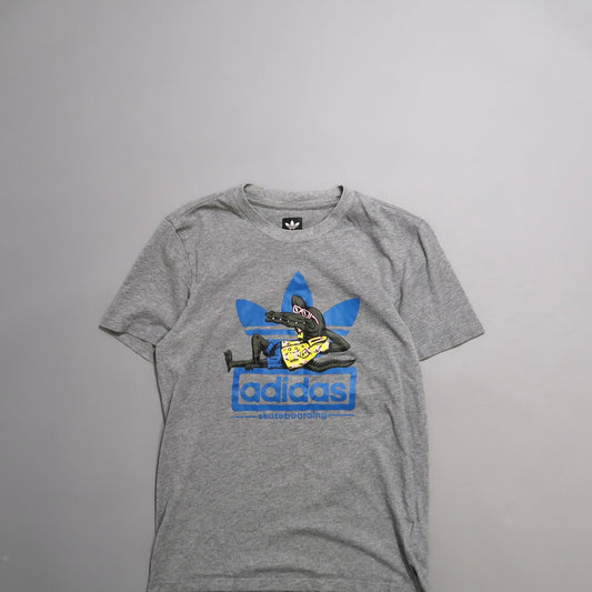 Gray T-shirt with blue Adidas logo and cartoon graphic.