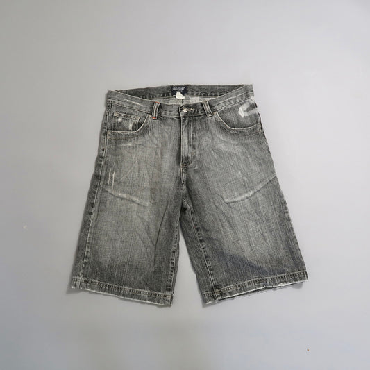 Worn gray denim shorts on a plain background.