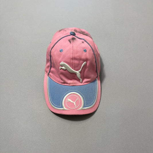 Pink and blue cap with Puma logo on a gray background.