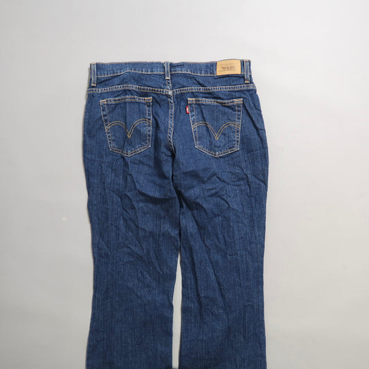 Back view of blue denim jeans with visible pockets and belt loops.
