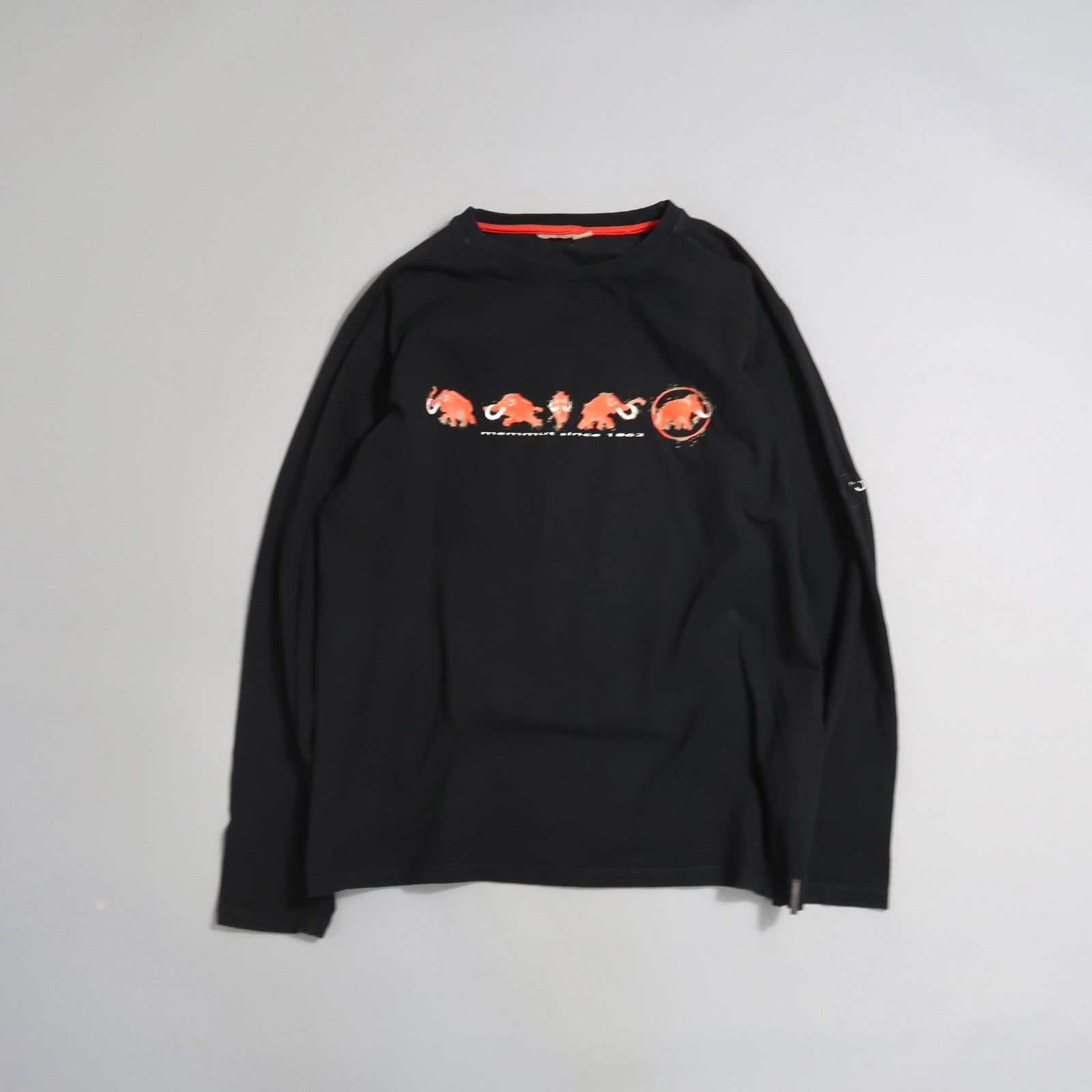 Black long-sleeve shirt with red animal graphics and text.