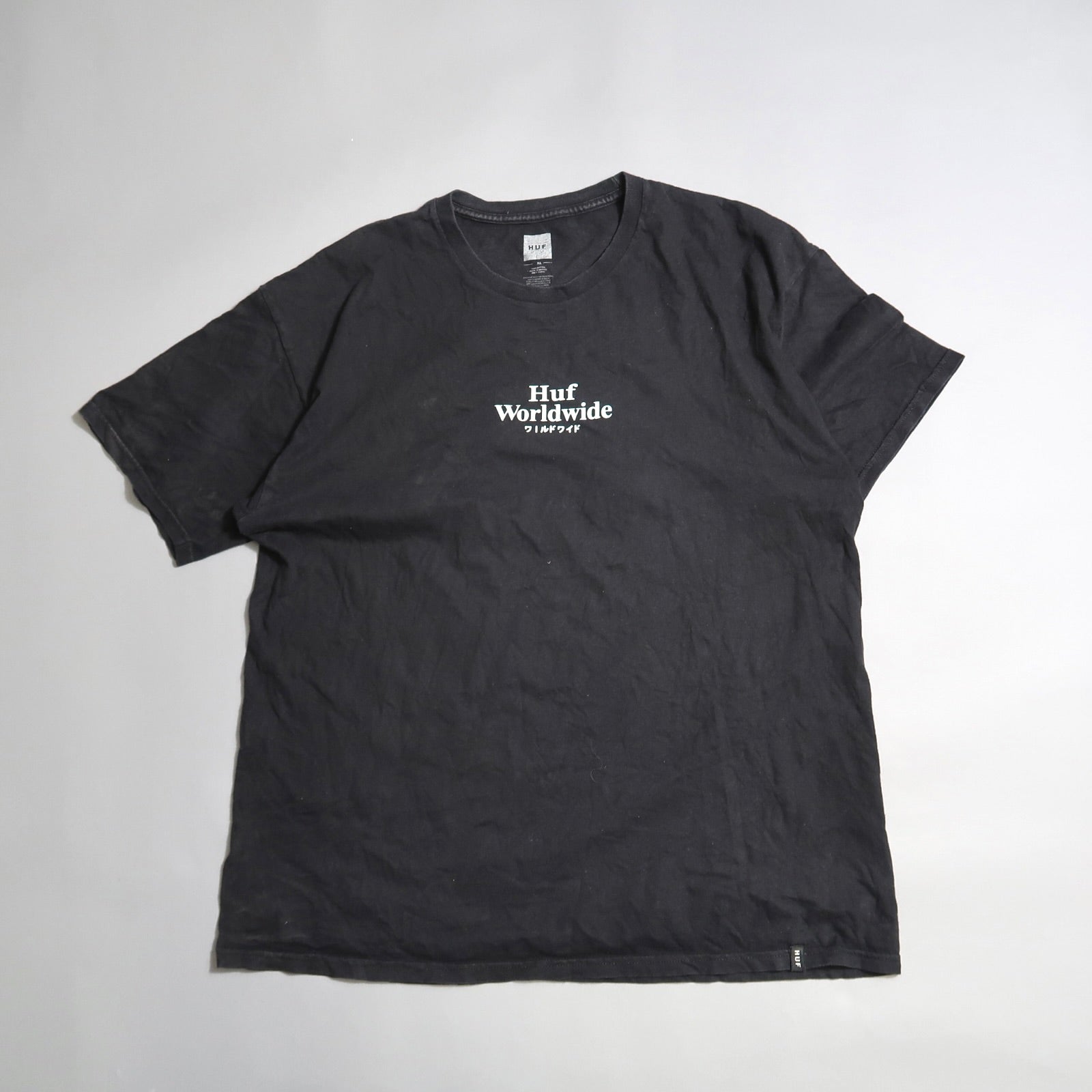 Black T-shirt with nullHuf Worldwidenull text on a plain background.