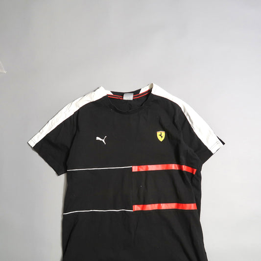Black T-shirt with white and red accents, featuring a yellow logo.